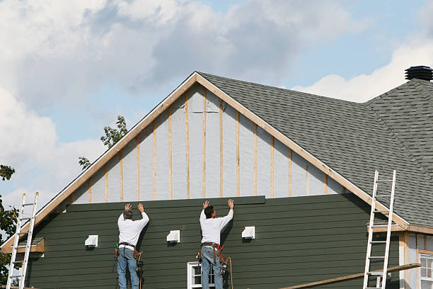 Professional Storm Damage Siding Repair technician working in Loretto, TN